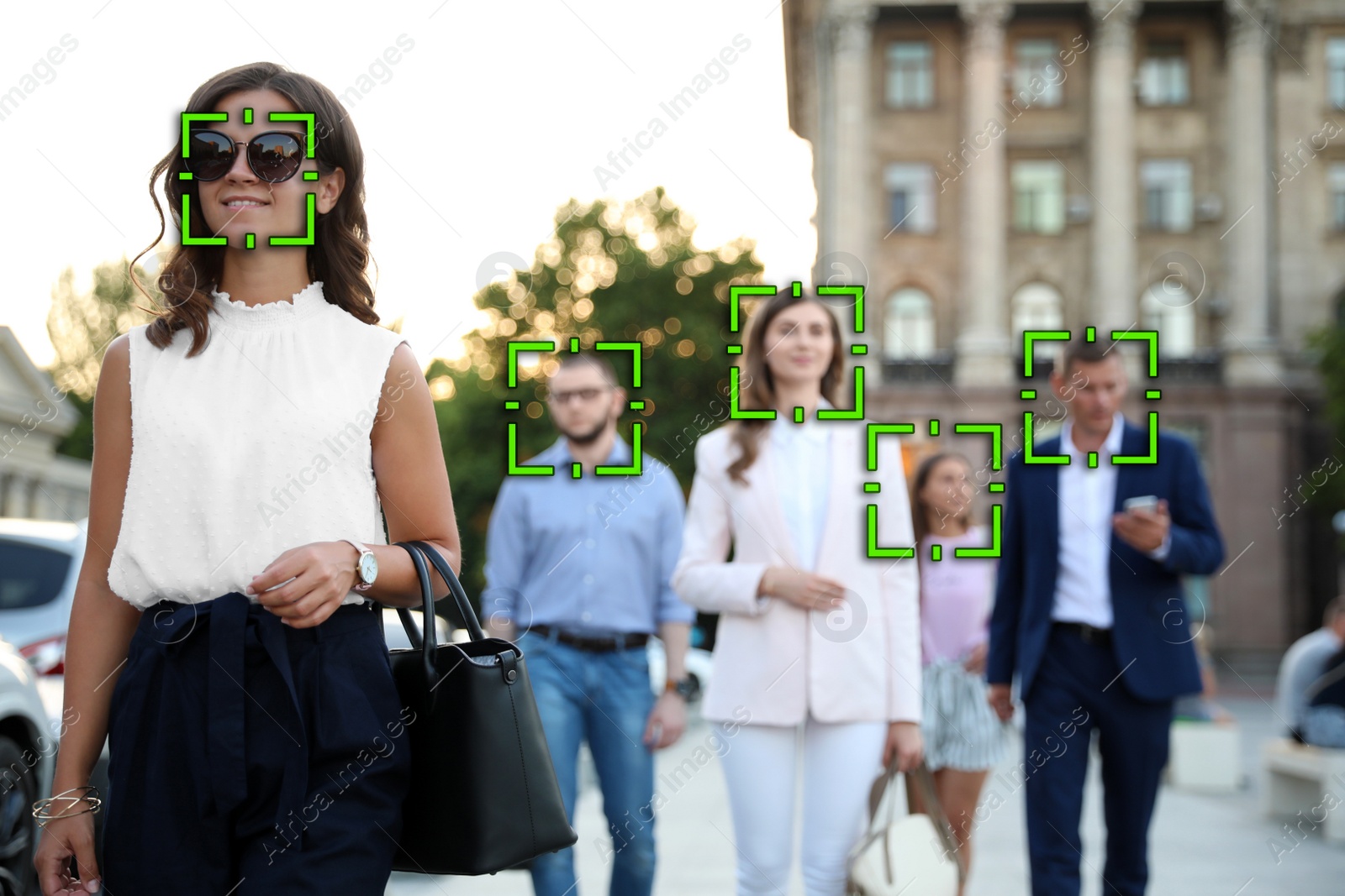 Image of Facial recognition system identifying people on city street 