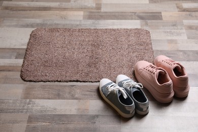 New clean door mat and shoes on floor