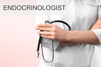 Endocrinologist with stethoscope on pale pink background, closeup