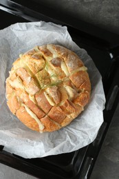 Freshly baked bread with tofu cheese on grey table, top view