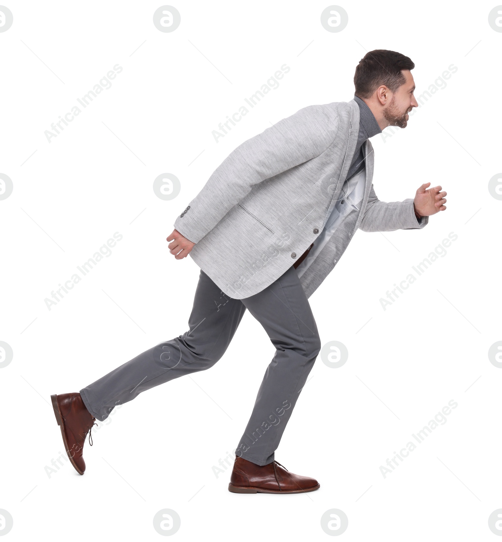 Photo of Handsome bearded businessman running on white background