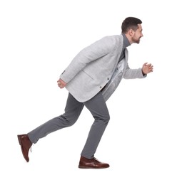 Handsome bearded businessman running on white background