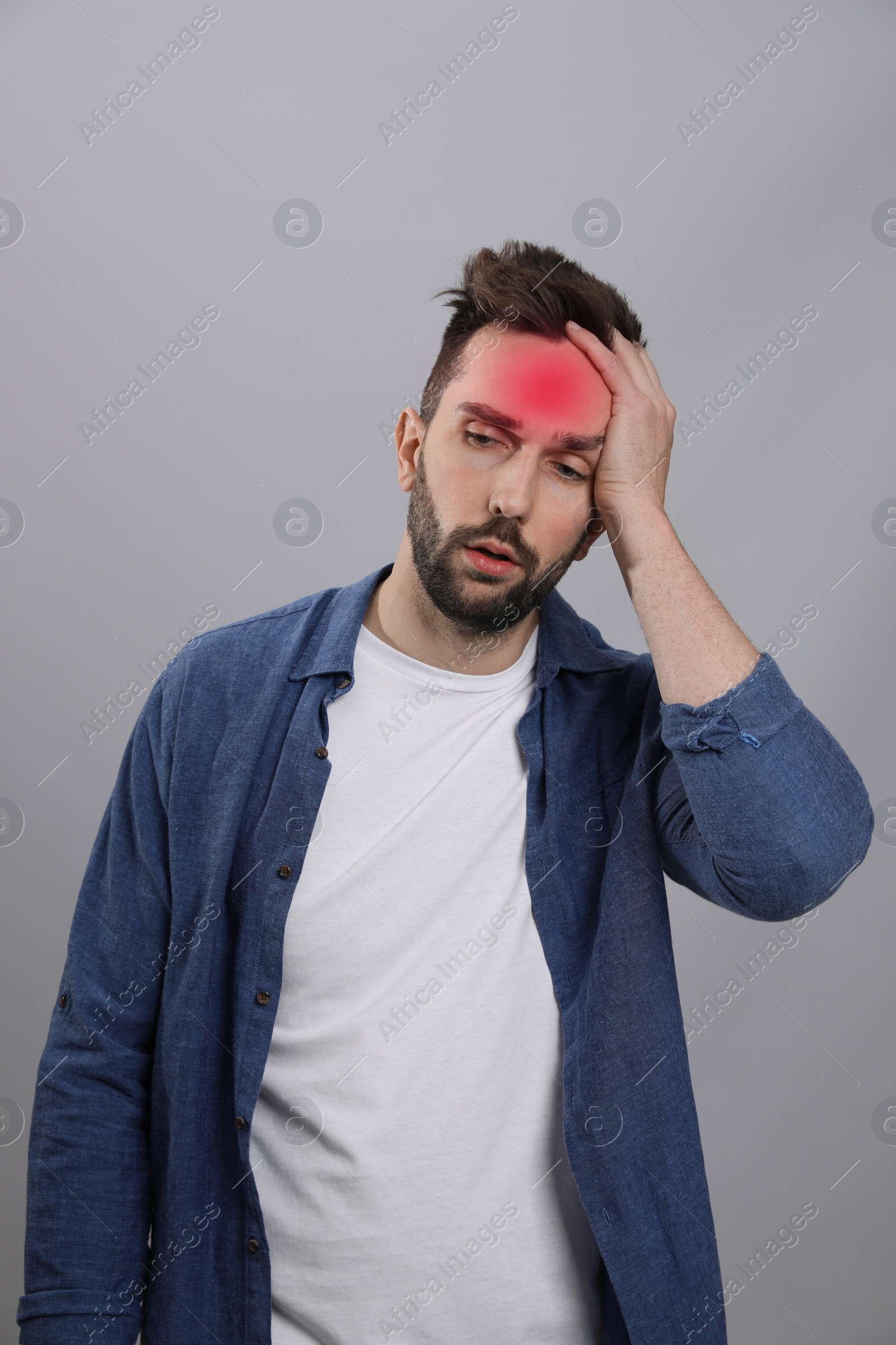Image of Man suffering from headache on grey background. Cold symptoms