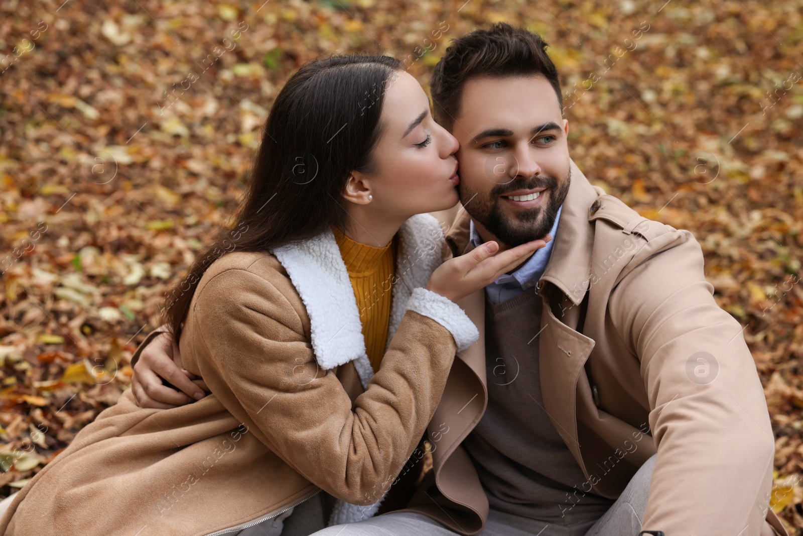 Photo of Happy young couple spending time together in autumn park