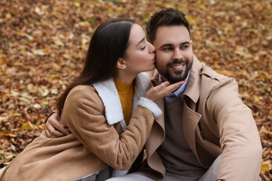Photo of Happy young couple spending time together in autumn park