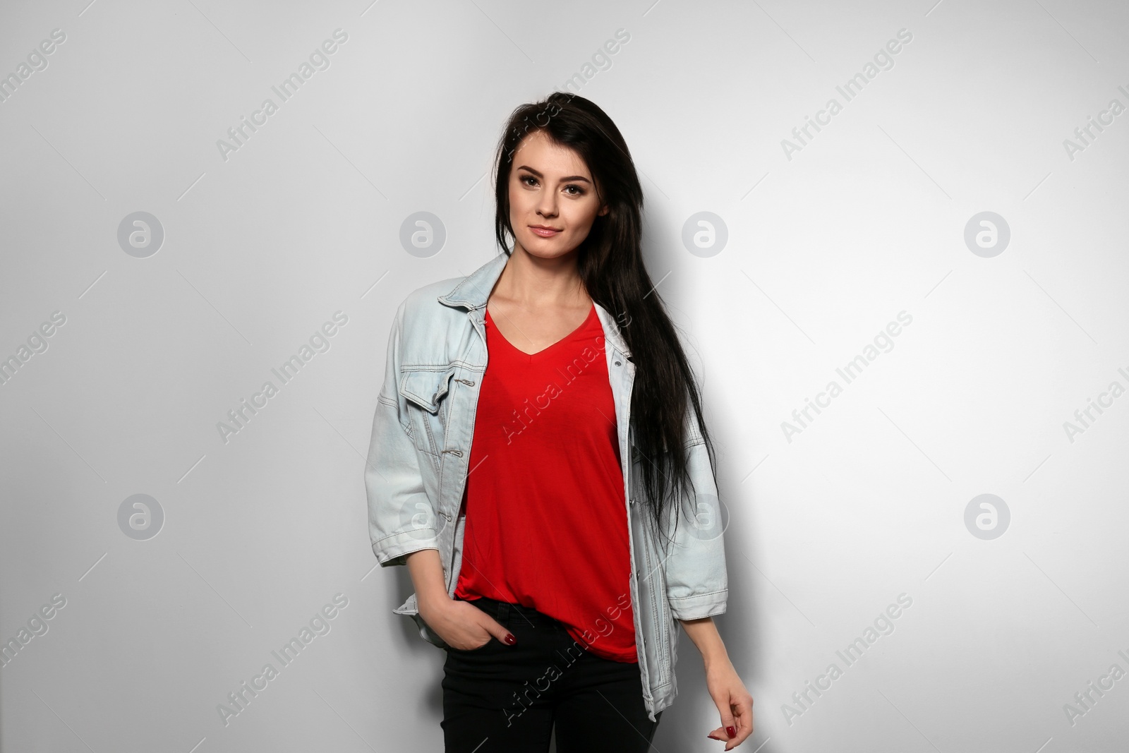 Photo of Portrait of stylish woman on light background