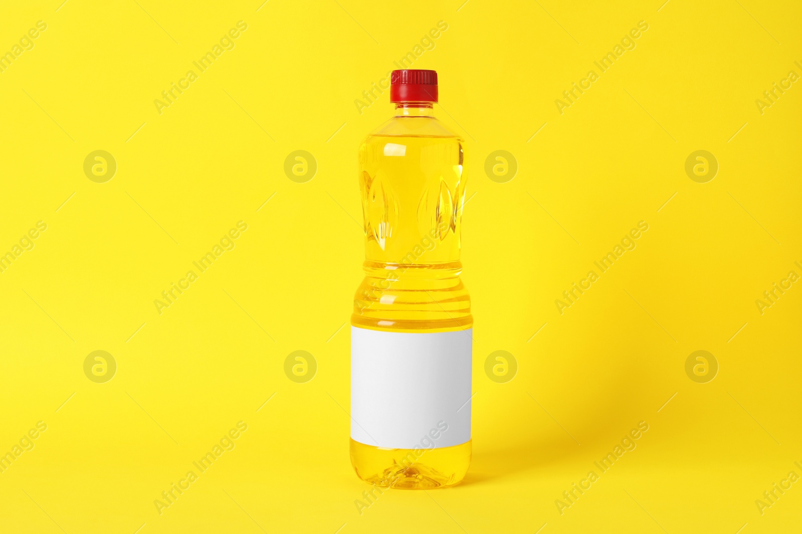 Photo of Bottle of cooking oil on yellow background