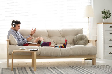 Businessman in shirt and underwear having video call on laptop at home