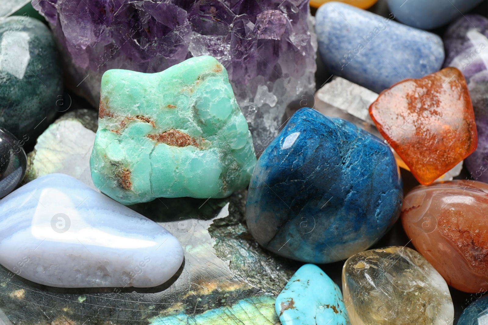 Photo of Different precious gemstones as background, closeup view