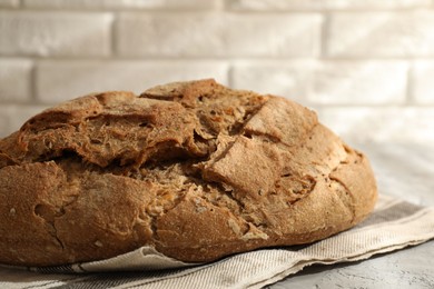 Photo of Freshly baked sourdough bread on grey table, closeup