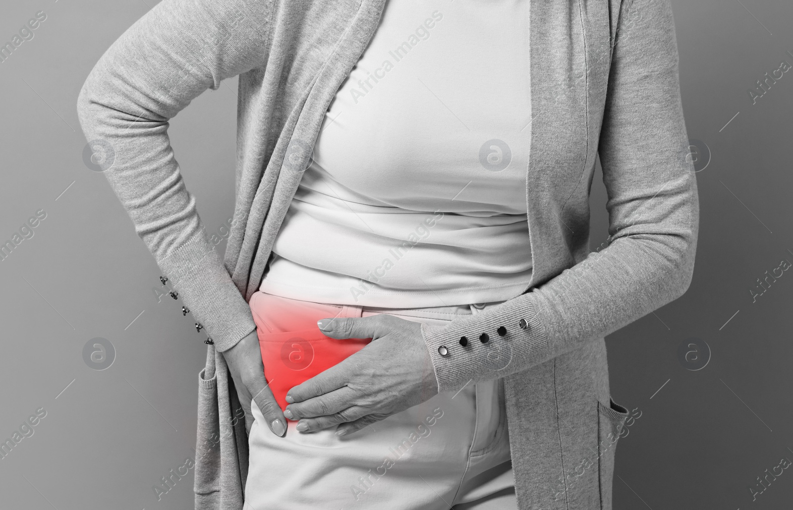 Image of Woman suffering from pain in hip, closeup. Black and white effect