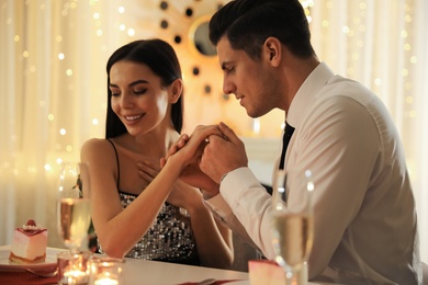 Photo of Happy couple having romantic dinner on Valentine's day in restaurant