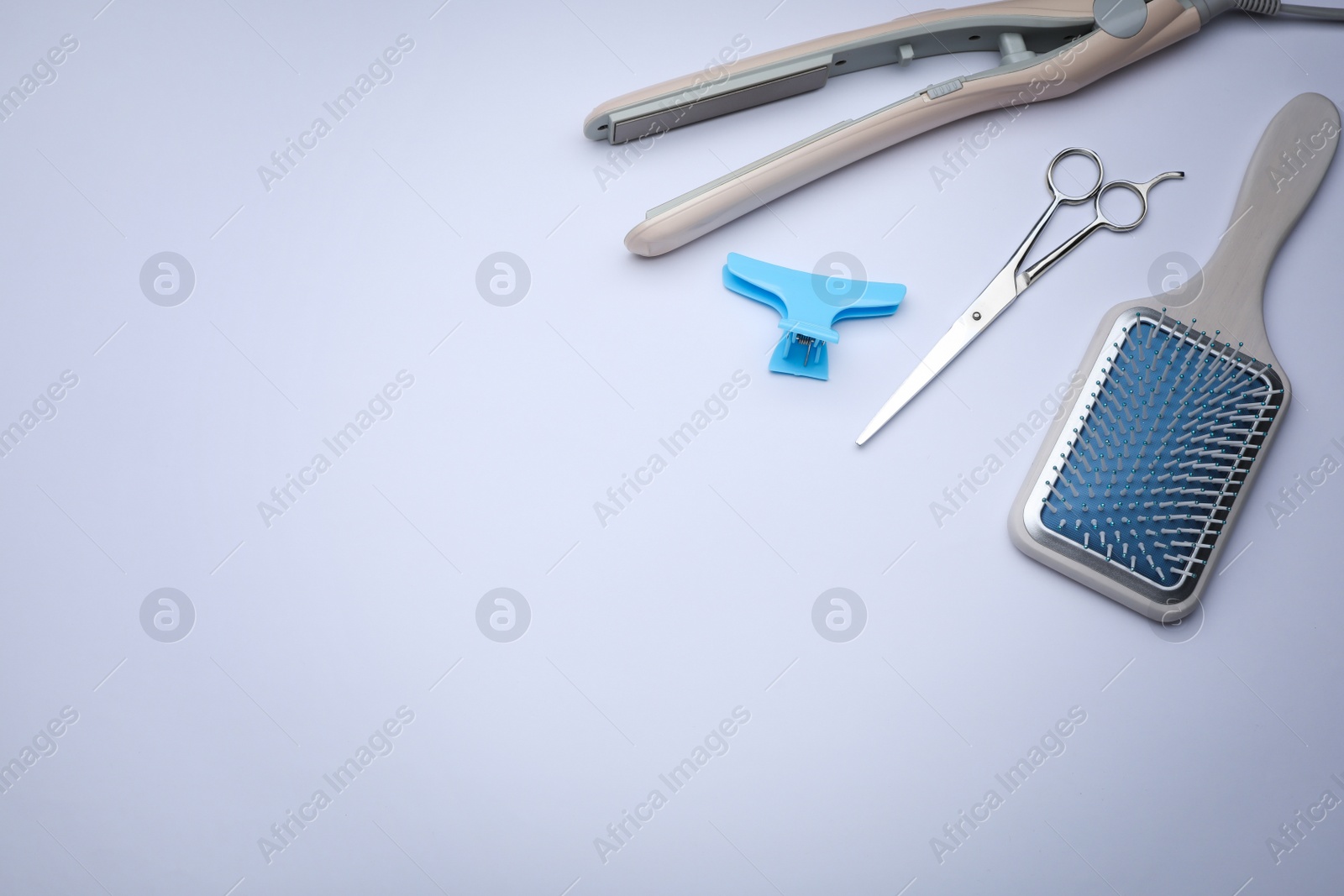 Photo of Composition with modern hair iron on white background, above view. Space for text
