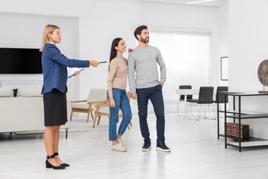 Photo of Real estate agent showing new apartment to couple