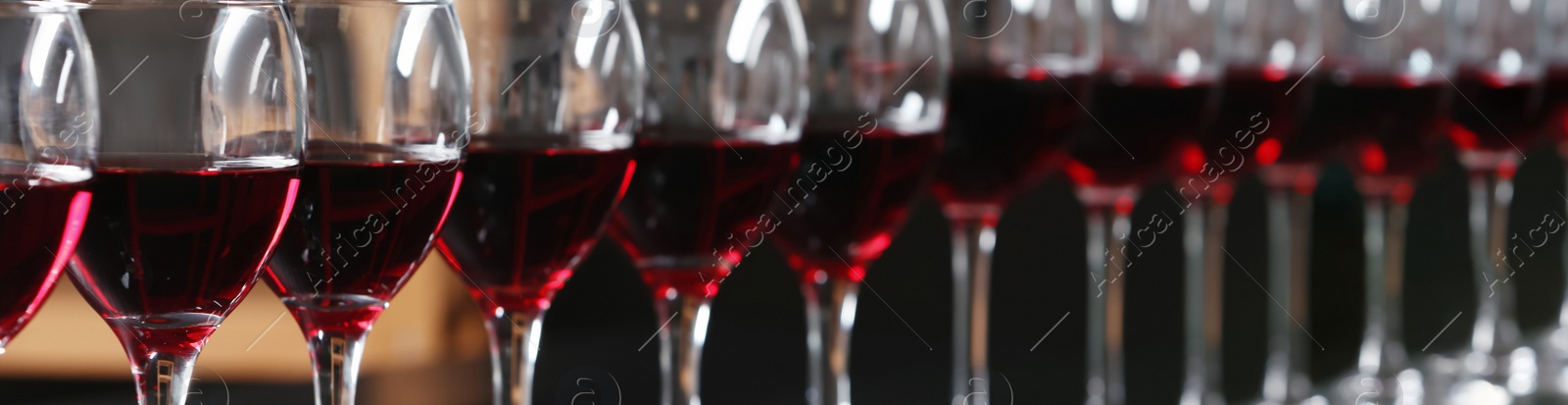 Image of Glasses with tasty red wine, closeup view. Banner design