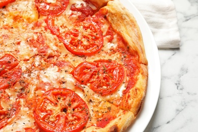 Hot cheese pizza Margherita on marble table, closeup