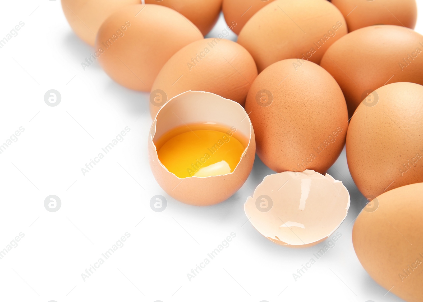 Photo of Cracked and whole chicken eggs on white background