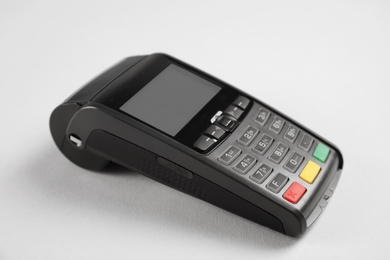 Photo of New modern payment terminal on grey background