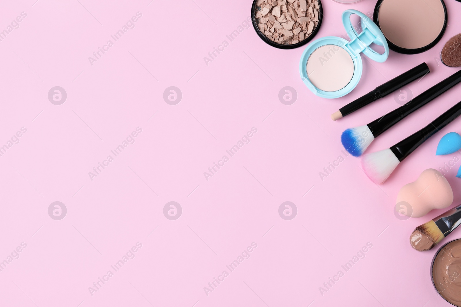 Photo of Flat lay composition with skin foundation, powder and beauty accessories on color background. Space for text