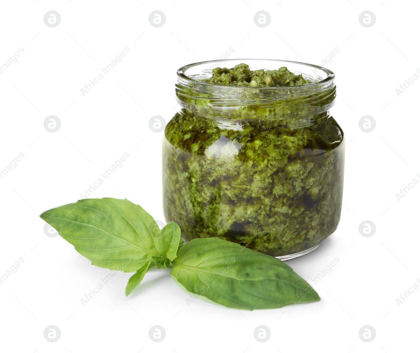 Photo of Jar of tasty pesto sauce and basil leaves isolated on white