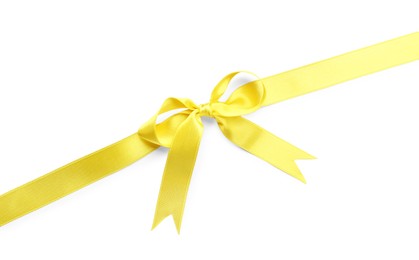 Yellow satin ribbon with bow on white background, top view