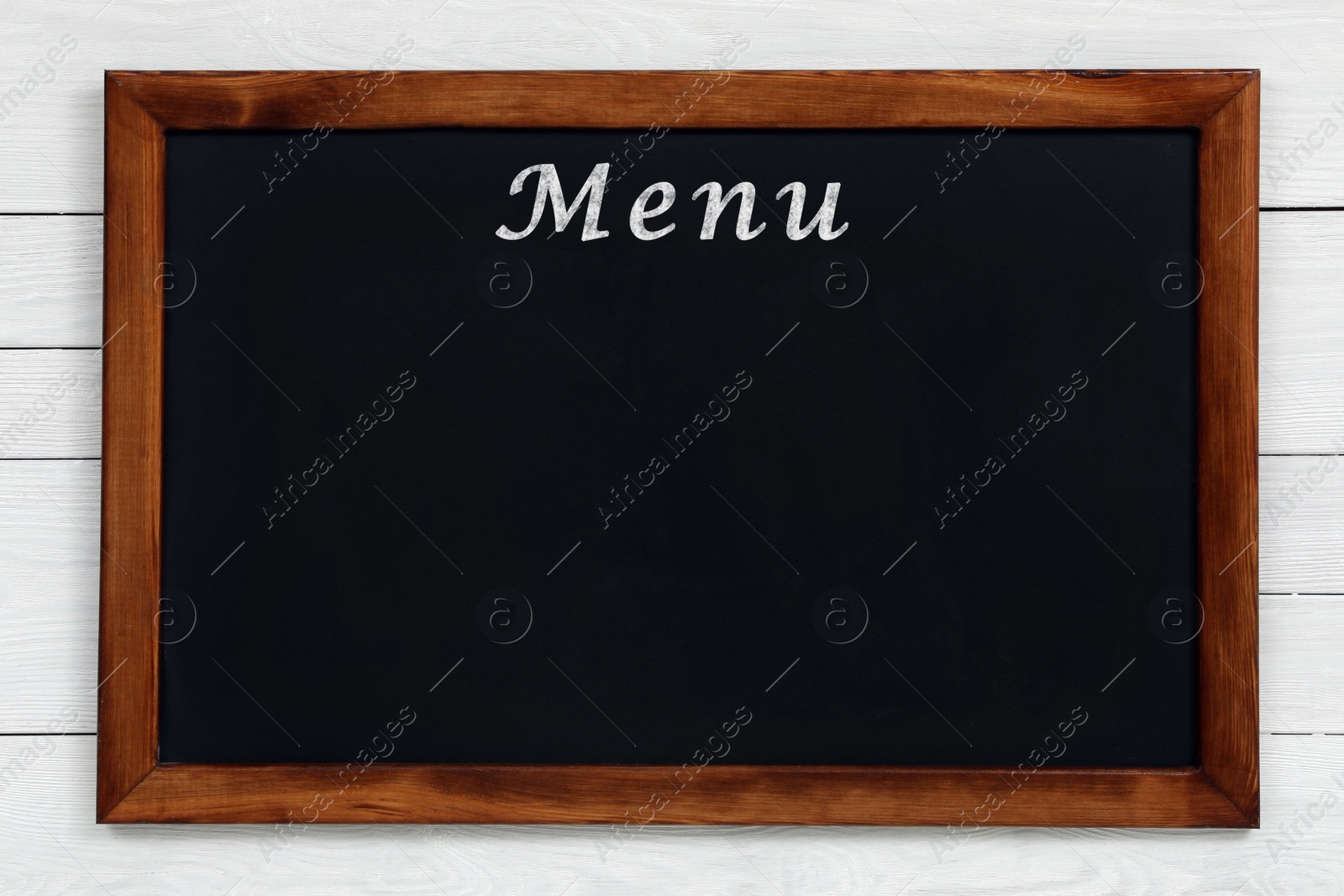 Image of Black chalkboard with word Menu on white wooden background. Mockup for design