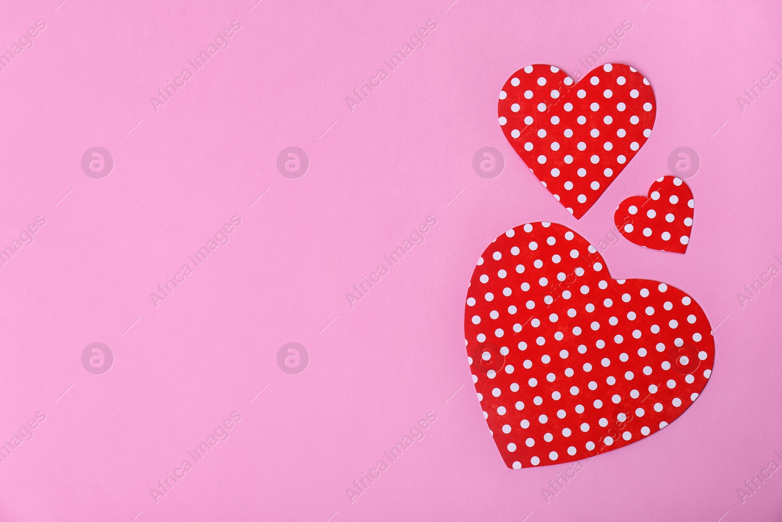 Photo of Paper hearts and space for text on color background, top view