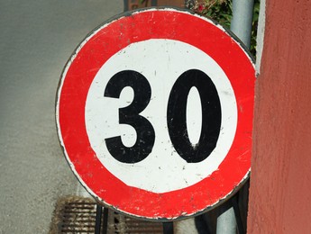 Road sign MAXIMUM SPEED 30 outdoors on sunny day