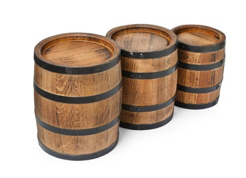 Photo of Three traditional wooden barrels on white background