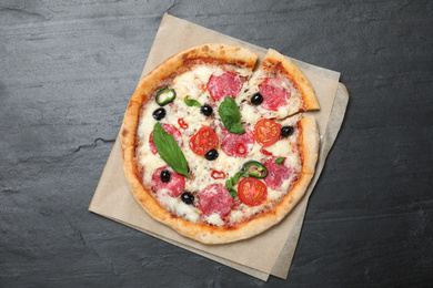 Photo of Delicious pizza Diablo on dark background, top view