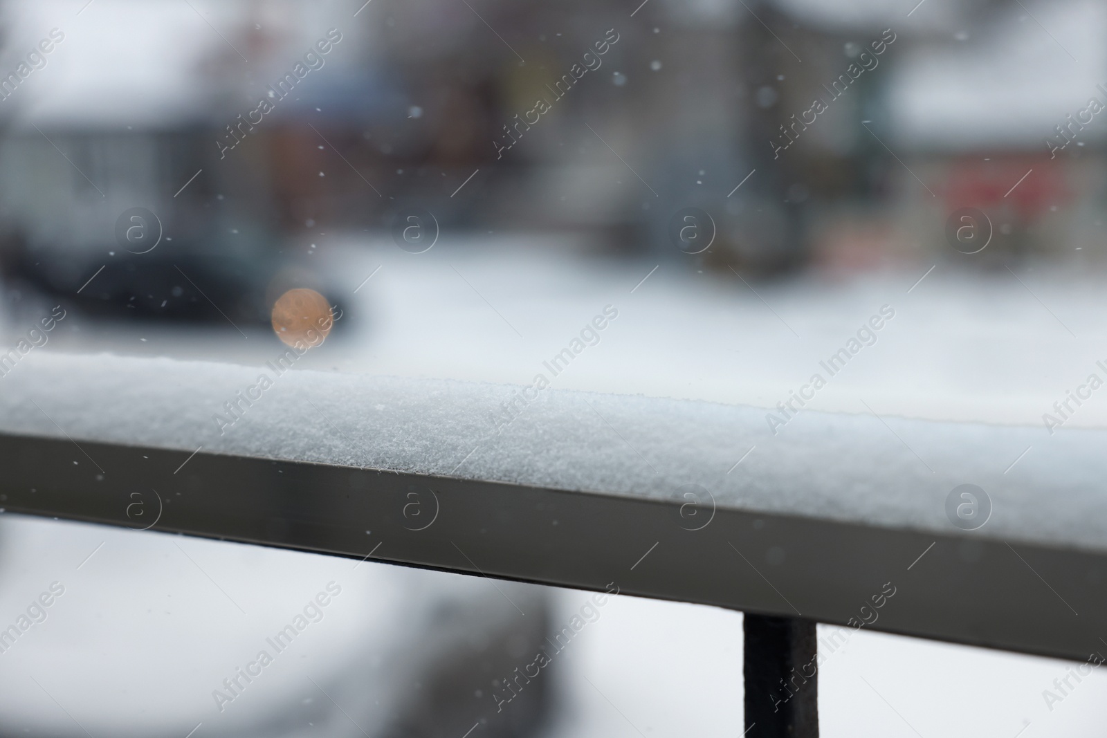 Photo of Handrail covered with snow outdoors, closeup view