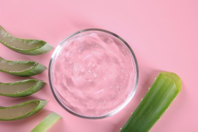 Aloe vera leaves and cosmetic gel on pink background, top view