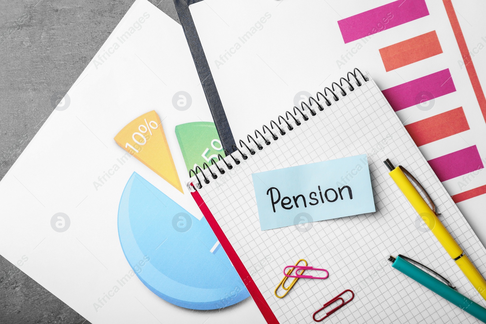 Photo of Paper with word Pension, stationery, notebook and charts on table, top view