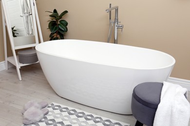 Photo of Cozy bathroom interior with stylish ceramic tub