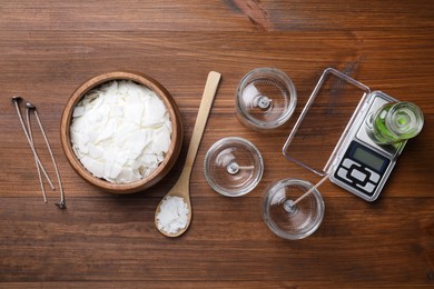 Photo of Flat lay composition with ingredients for homemade candles on wooden background