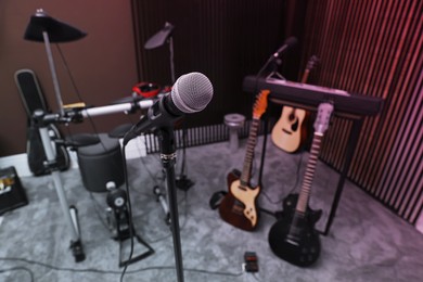 Photo of Modern microphone at recording studio. Music band practice