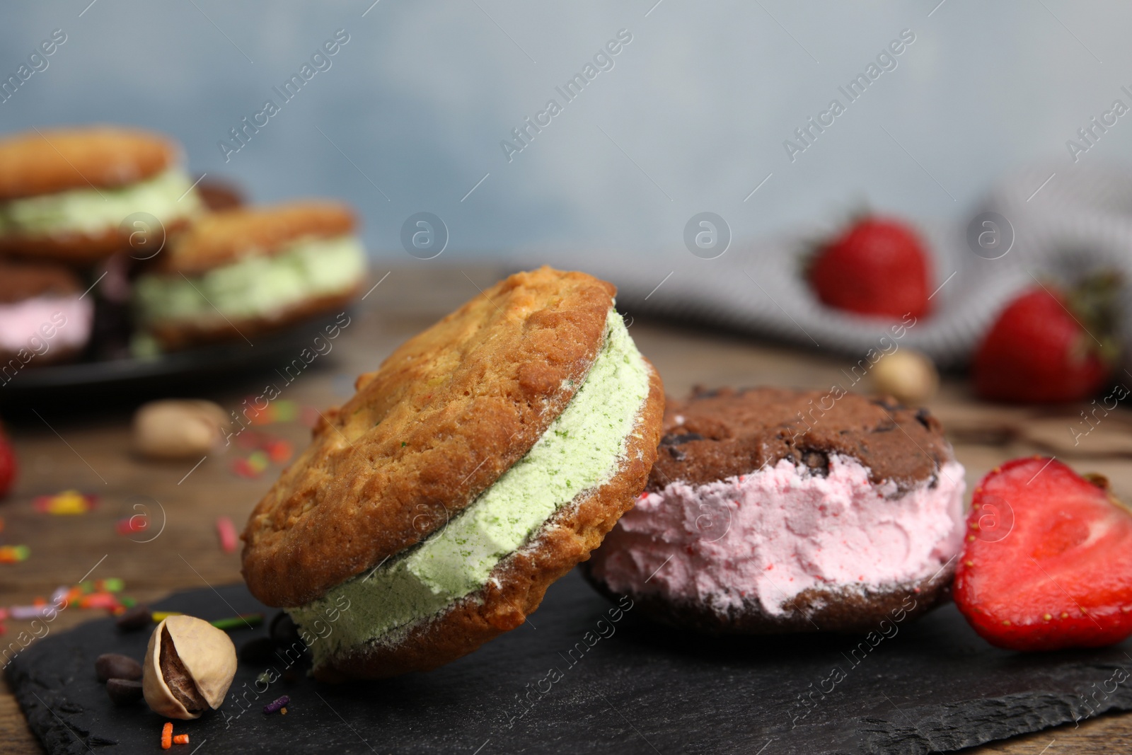 Photo of Sweet delicious ice cream cookie sandwiches on table