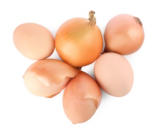 Photo of Easter eggs painted with natural dye and onions on white background, top view