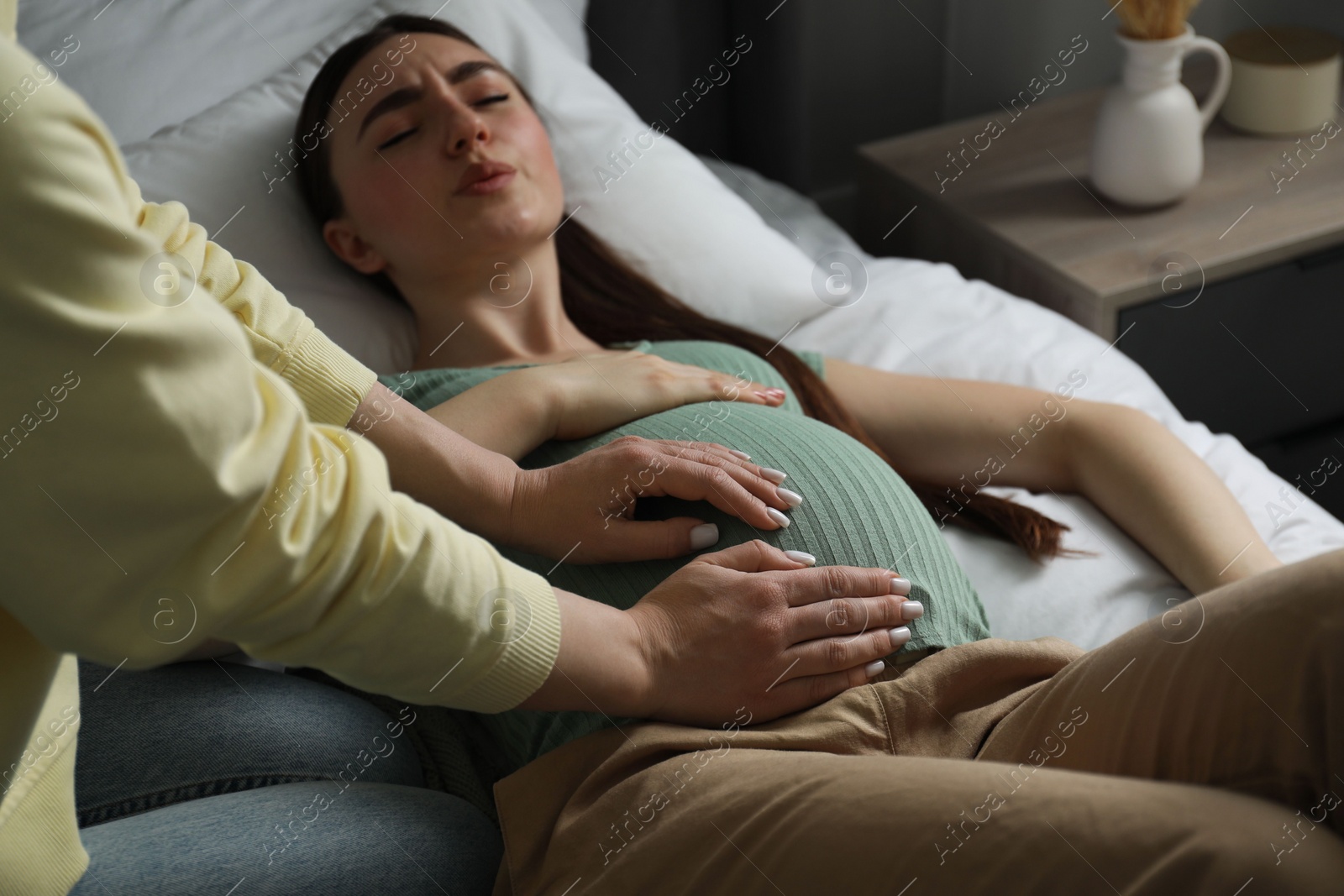 Photo of Doula working with pregnant woman indoors. Preparation for child birth