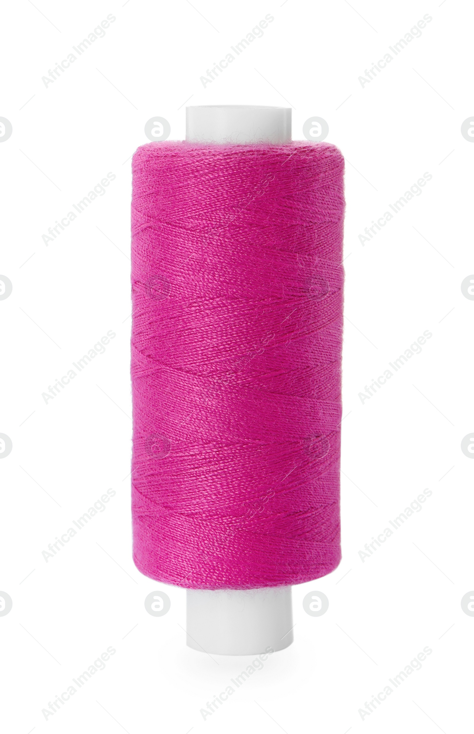 Photo of Spool of pink sewing thread isolated on white