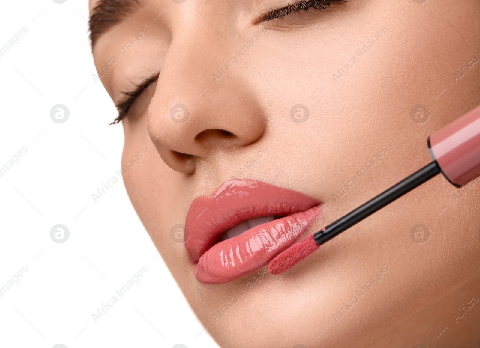 Photo of Woman applying lip gloss on white background, closeup