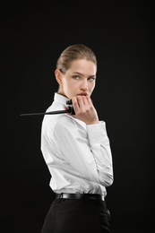 Photo of Female security guard using portable radio transmitter on dark background