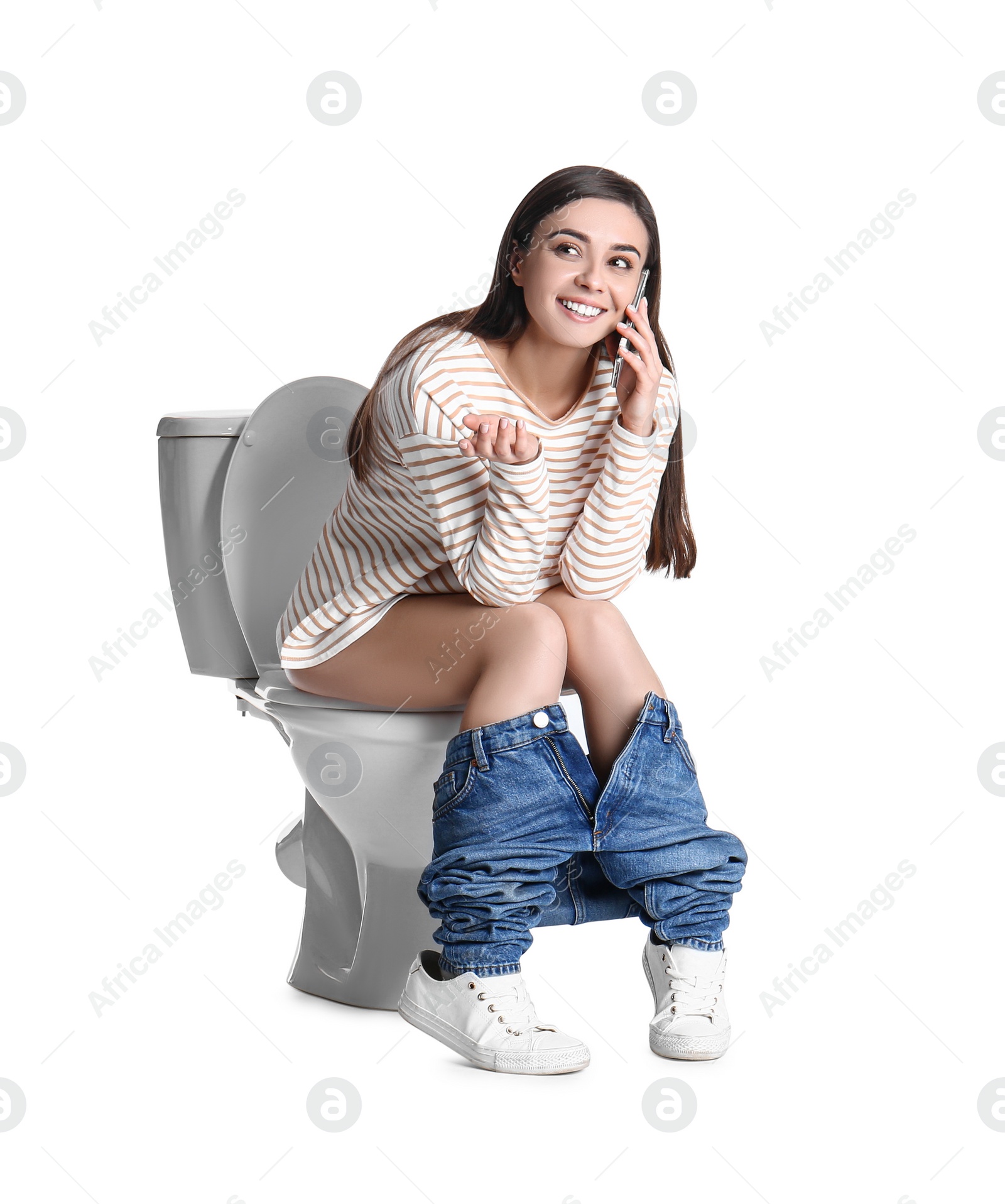 Photo of Woman with smartphone on toilet bowl, white background