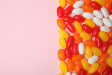 Photo of Flat lay composition with jelly beans on color background. Space for text