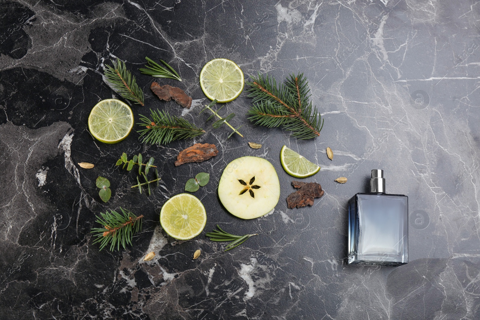 Photo of Flat lay composition with bottle of perfume on black marble background