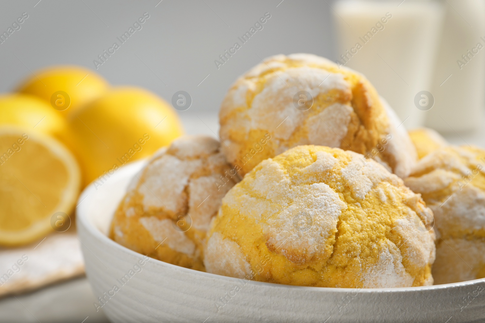 Photo of Delicious lemon cookies in bowl on table, closeup