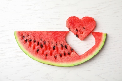 Photo of Slice of watermelon on white wooden background, top view