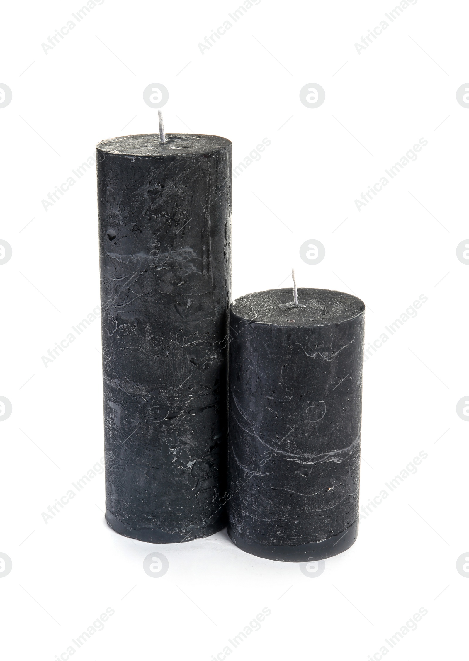 Photo of Two decorative wax candles on white background