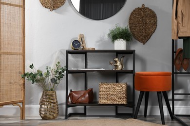 Stylish room interior with console table and beautiful decor elements