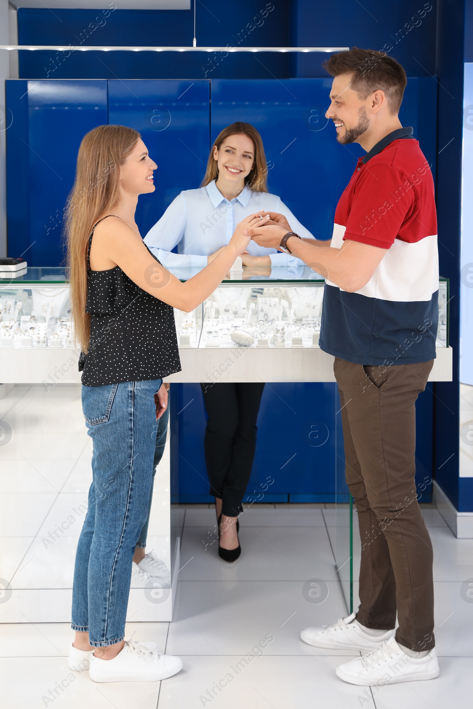 Photo of Couple choosing engagement ring in jewelry store